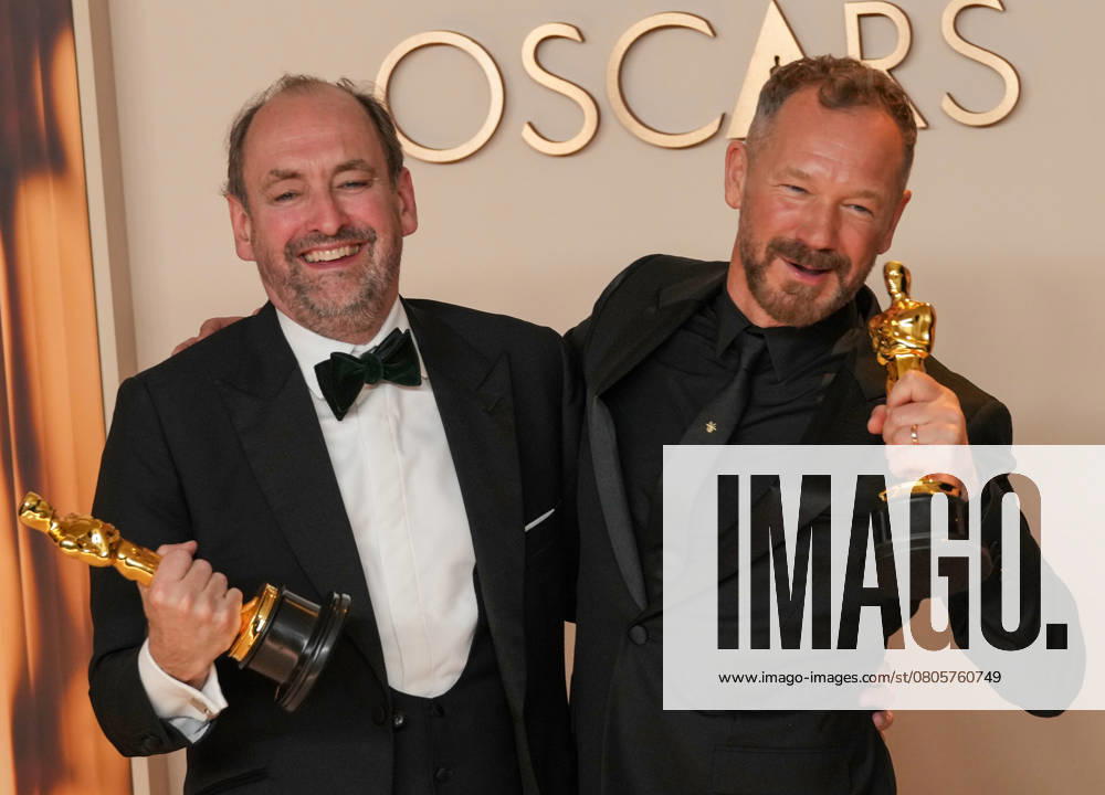 Nathan Crowley and Lee Sandales of Wicked celebrate backstage after winning the Oscar for best production design during the 97th Academy Awards in the Hollywood section of Los Angeles on Sunday, March 2, 2025. LAP20250302128 PATxBENIC