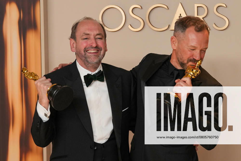 Nathan Crowley and Lee Sandales of Wicked celebrate backstage after winning the Oscar for best production design during the 97th Academy Awards in the Hollywood section of Los Angeles on Sunday, March 2, 2025. LAP20250302129 PATxBENIC