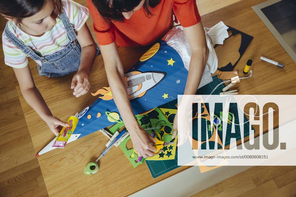 Mother and daughter creating her space themed school cone at home model released Symbolfoto property released MFF03772