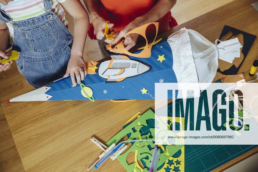 Mother and daughter creating her space themed school cone at home model released Symbolfoto property released MFF03706