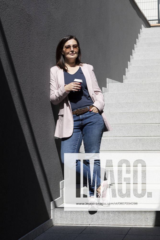 Smiling Beautiful Brunette Woman Hold Paper Cup Of Coffee Standing On Stairs Near Office Outdoor, Dressed In Stylish Casual Clothes, Summer Sunny Day. Taking A Break. Lifestyle Portrait Mature Female, model released, , 53043600.jpg, smiling, mature, woman, holding, coffee, cup, paper, outdoor, elderly, 40s, stylish, hold, brunette, lifestyle, cloth, casual, break, lunch, female, lady, work, business, beautiful, attractive, pretty, brown, hair, summer, hi, tech, technology, street, digital, nomad, businesswoman, worker, adult, person, building, professional, specialist, sunglasses, relax, rest, enjoy, smart, outfit, city, modern, daytime RECORD DATE NOT STATED