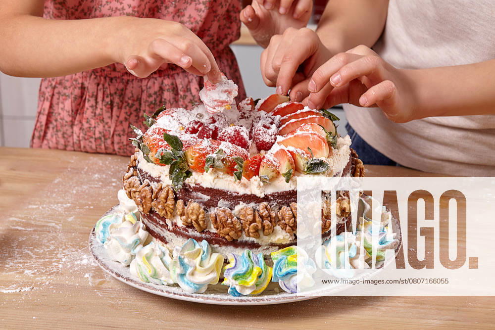 Little boy dressed in a light t-shirt and jeans and a girl wearing in a pink dress are making a cake at a kitchen. They are decorating the cake with some strawberry., model released, , 53269662.jpg, girl, boy, cake, child, cooking, flour, preparation, young, pretty, funny, home, kitchen, smile, background, studio, pie, sweet, little, indoor, fruits, children, interior, meal, marshmallow, table, colorful, furniture, wooden, t-shirt, jeans, dress, strawberry, braid, ingredients, raspberry, fresh, culinary, plate, childhood, powdered sugar, cheese, walnuts, dish, glass, orange, cream, male, female, kids, decorating RECORD DATE NOT STATED