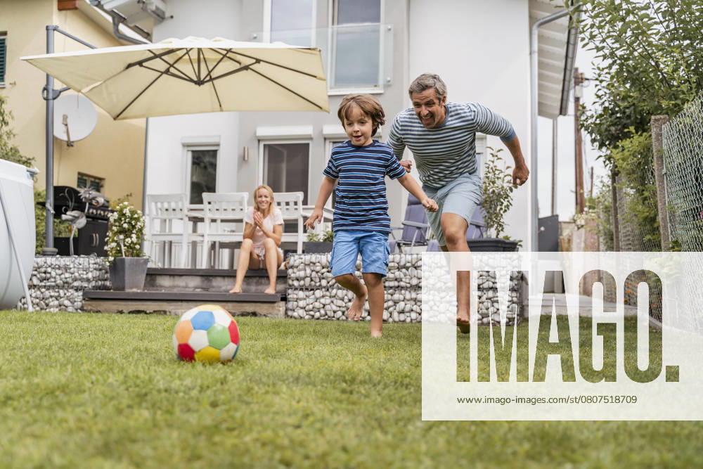 Father and son playing football in garden model released, Symbolfoto property released, DIGF08243