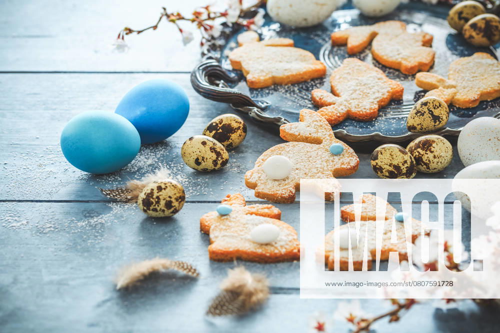 Homemade almond bunny cookies for Easter with Easter eggs in blue tone Homemade almond bunny cookies for Easter with Easter eggs in blue tone