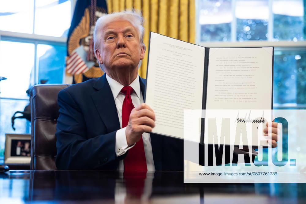 United States President Donald J Trump holds-up an Executive Order imposing a 25% tariff on imports of automobiles and certain automobile parts in the Oval Office of the White House in Washington, DC, US, on Wednesday, March 26, 2025 Washington USA - ZUMAs152 20250326_faa_s152_028