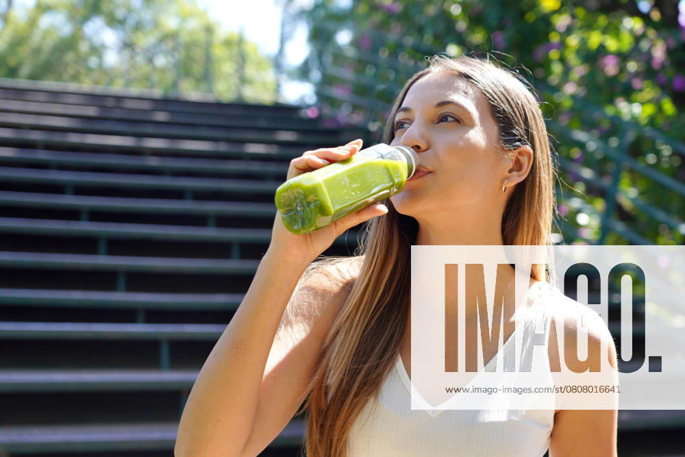 Beautiful healthy young woman drinking green smoothie detox juice outdoors, model released, , 57079020.jpg, Attractive, Happy, beautiful, bottle, brazil, brazilian, city, content, copy space, detox, diet, drinking, energy, female, fit, food, fresh, girl, green, happiness, health, healthy, hispanic, juice, kale, kiwi, latin, looking to the side, mexican, mint, morning, natural, nourishment, outdoors, park, people, portrait, runner, smiling, smoothie, summer, supplements, vegan, vegetables, vegetarian, vitamins, weight loss, wellness, woman, young RECORD DATE NOT STATED