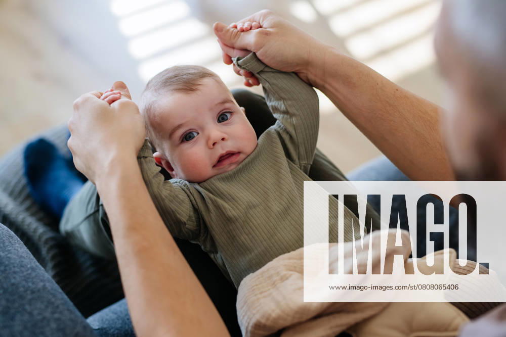Portrait of baby boy on his father s lap. Portrait of a baby boy on his father s lap. model released