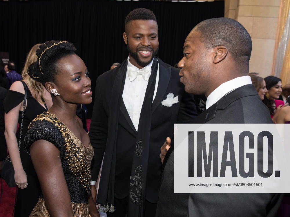 90th Oscars¨, Academy Awards, Arrivals Lupita Nyong o, Winston Duke (center) and guest arrive for the live ABC Telecast of The 90th Oscars¨ at the Dolby¨ Theatre in Hollywood, CA on Sunday, March 4, 2018. Hollywood CA USA