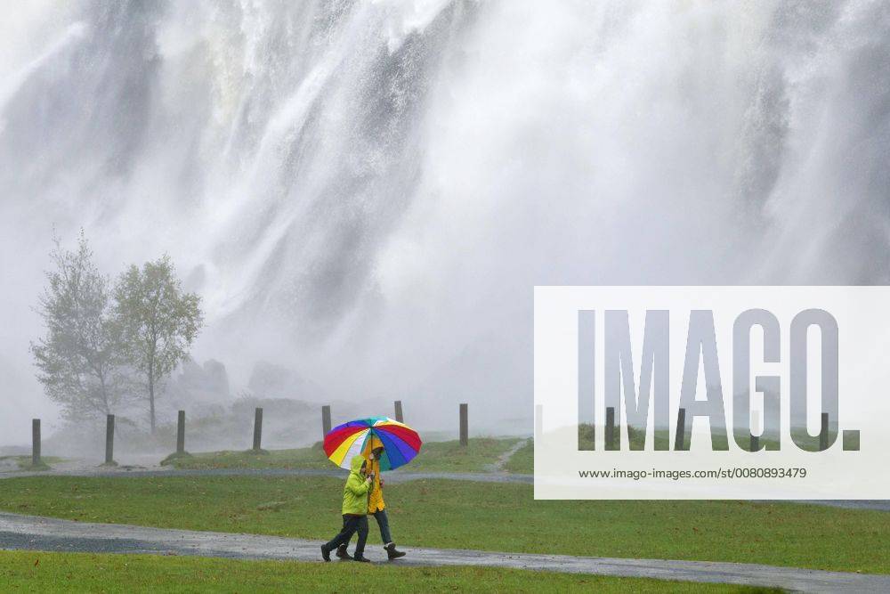 Walkers with colorful Umbrella before Waterfall Powerscourt Court Waterfall Enniskerry County Wicklow Ireland Europe