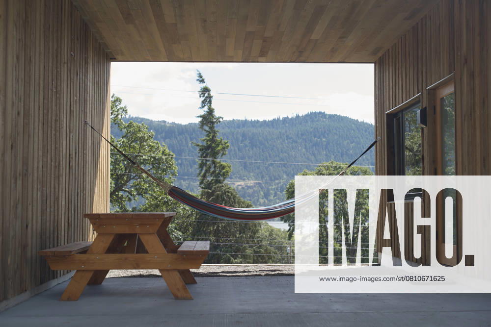Wooden patio with hammock and picnic table overlooking forested hills. Oregon, USA Oregon USA bola07948