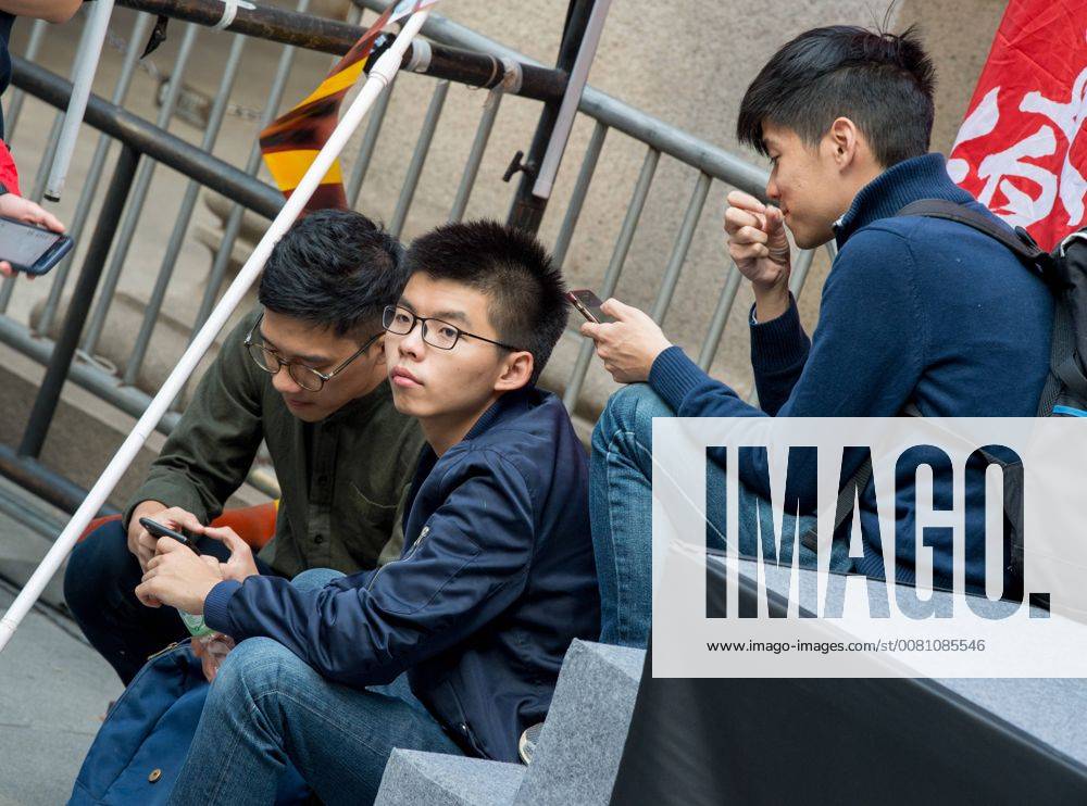 Hong Kong, Hong Kong SAR, CHINA - HONG KONG SAR,CHINA: December 03, 2017. Nathan Law (L), Joshua Wong (M) and Lester Shum (R) await their turn to speak.Pro-democracy activists march against Hong Kong s Ã¢â‚¬oeauthoritarianÃ¢â‚¬Â regime, possibly the last time before many of them are jailed. Bailed protesters Joshua Wong and Nathan Law joined supporters for the march from Wan Chai to the Final Court of Appeal in Central Hong Kong CHINA - ZUMAr144 20171203_zap_r144_002