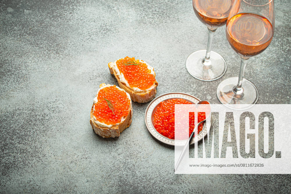 Small metal plate with red salmon caviar, two caviar toasts canape, two glasses of champagne top view on grey concrete background, festive luxury delicacy and appetizer. , 58531384.jpg, seafood, caviar, fish, red, salmon, luxury, delicacy, sandwich, canape, champagne, sparkling wine, drink, healthy, food, snack, expensive, trout, macro, red caviar, ingredient, raw, orange, bread, epicure, fresh, deli, close-up, salty, gourmet, roe, appetizer, from above, protein, delicatessen, indulgence, omega, butter, savoury, glass, sea, celebrate, elegance, new year, simplicity, treat, wealth, french, baguette RECORD DATE NOT STATED