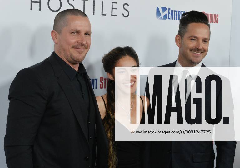 Cast members Christian Bale and Q orianka Kilcher join director Scott Cooper (R) on the red carpet during the premiere of the motion picture western Hostiles at the Academy of Motion Picture Arts & Sciences in Beverly Hills, California on December 14, 2017. Storyline: In 1892, a legendary Army captain reluctantly agrees to escort a Cheyenne chief and his family through dangerous territory. LAP2017121404 JIMxRUYMEN