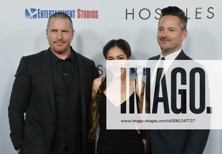 Cast members Christian Bale and Q orianka Kilcher join director Scott Cooper (R) on the red carpet during the premiere of the motion picture western Hostiles at the Academy of Motion Picture Arts & Sciences in Beverly Hills, California on December 14, 2017. Storyline: In 1892, a legendary Army captain reluctantly agrees to escort a Cheyenne chief and his family through dangerous territory. LAP2017121406 JIMxRUYMEN