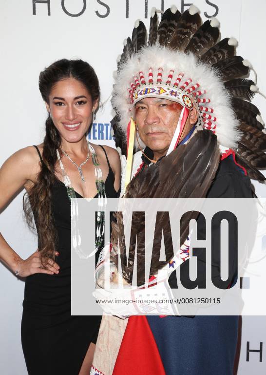 BEVERLY HILLS, CA - DECEMBER 14: Q Orianka Kilvcher, Chief Phillip Whiteman Jr., at Premiere Of Entertainment Studios Motion Pictures Hostiles at Samuel Goldwyn Theater, In Beverly Hills, California on December 14, 2017.
