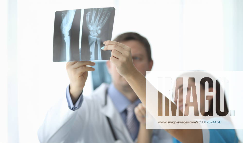 Close-up of female and male hands holding x-ray. Traumatologist and surgeon making diagnosis to patient. Practitioners discussing trauma. Traumatology and healthcare concept, model released, , 59009204.jpg, closeup, female, male, hand, holding, x-ray, skiagram, traumatologist, surgeon, diagnosis, patient, practitioner, discuss, trauma, traumatology, healthcare, concept, advice, colleague, work, hospital, look, xray, doctor, physician, examining, shadowgraph, therapist, medicine, disease, clinical, unhealthy, recovery, expert, clinic, specialist, healing, sick, illness, intern, practice, treatment, medic, medicines, professional, injury, diagnostic, cabinet, health, healthy RECORD DATE NOT STATED