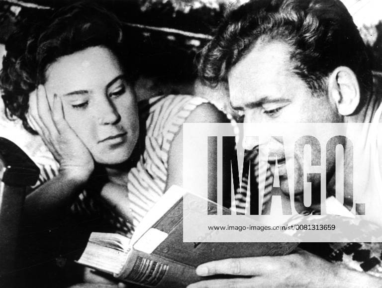 Major Gherman Stepanovich Titov, the second Soviet astronaut launched into space aboard Vostok II with Madame Tamara Titov his wife , reading a book at their home. 7 August 1961, Moscow Russia Federation