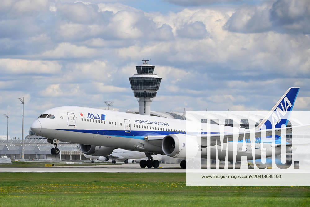 ANA All Nippon Airways JA89IA B787 Dreamliner takes off, takeoff in front of tower and terminal passenger jets at Franz Josef Strauss Airport in Munich Munich