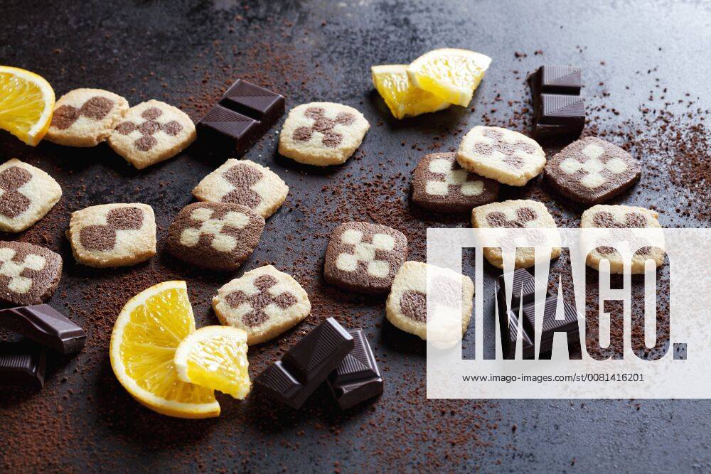 Black and white short crust Christmas cookies with orange slices and dark chocolate CSF28499