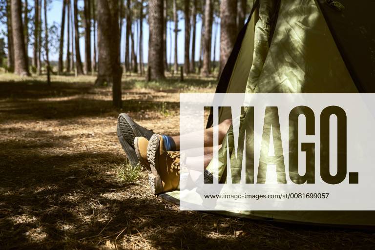 Shoes are sticking out of a tent in forest model released Symbolfoto SRYF00718