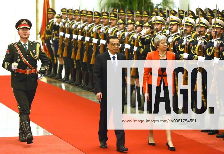 British Prime Minister Theresa May (R) and Chinese Premier Li Keqiang inspect a military honor guard during a welcoming ceremony in the Great Hall of the People in Beijing on January 31, 2018. May told China to stop flogging counterfeit goods and dumping steel as she risked a spat with Beijing at the start of a trade visit. PEK2018013105 STEPHENxSHAVER