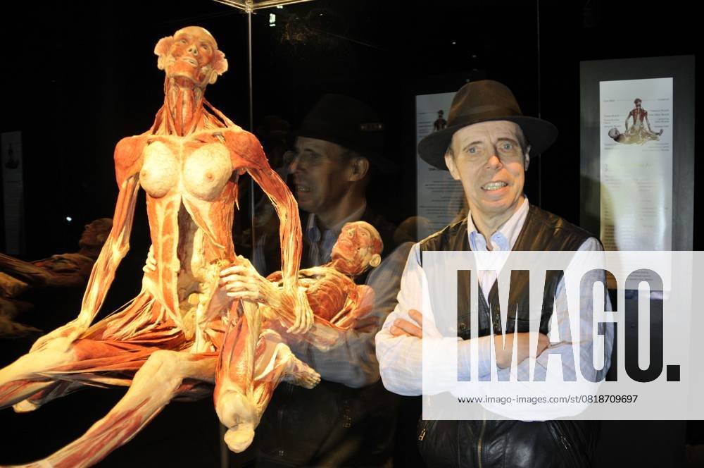 Body Worlds & the Mirror of Time exhibition DR. GUNTHER VON HAGENS & THE SUSPENDED ACT.Press conference for the new sex plastinates which is part of the Body Worlds & the Mirror of Time exhibition at the O2 Arena, Greenwich, south-east London, England..June 23rd, 2009.bodyworks body works half length muscles internal organs flesh muscle skin models bone sexual position half length black hat blue shirt waistcoat arms crossed .CAP PL.Phil Loftus . London Great Britain