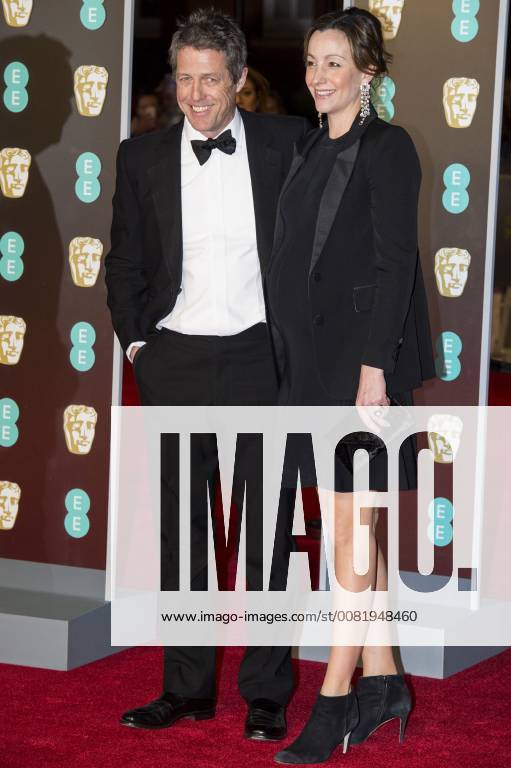 London, London, UK - Hugh Grant and Anna Eberstein arrives on the red carpet for the EE British Academy Film Awards 2018, held at the Royal Albert Hall. London UK - ZUMAt138 20180218_zap_t138_052