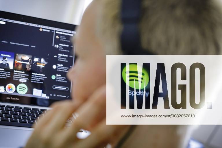 The logo of the music streaming service Spotify is reflected in a headphone Berlin 27 02 2018 Berlin Germany