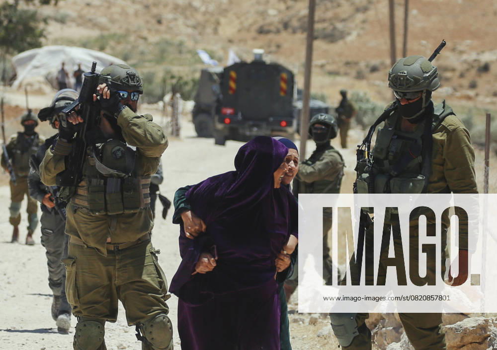 Demolishing Home and Barn in Hebron A Palestinian woman pulls another woman away as Israeli occupation soldiers advance during a raid in the Al-Jawaya area of Yatta, south of Hebron, West Bank on May 28, 2025. A house, home to a family of eight, was demolished along with a sheep barn by occupation forces. Herbon West Bank Palestinian Territories