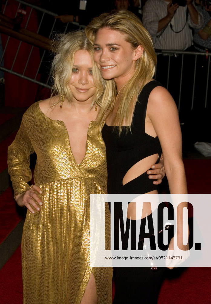Costume Institute Gala - Superheroes: Fashion and Fantasy MARY-KATE OLSEN & ASHLEY OLSEN Costume Institute Gala - Superheroes: Fashion and Fantasy at The Metropolitan Museum of Art, New York, NY, USA. May 5th, 2008 half length mary kate sisters twins siblings sisters family black gold dress hand on hip cut out away clutch bag CAP LNC TOM TOM LNC New York NY united States