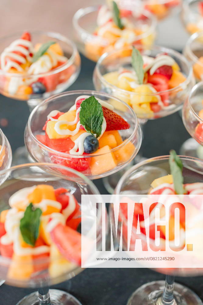 Fruit salad cups with yogurt drizzle and mint garnish Pittsburgh, Pennsylvania, United States R_QIWH250529-1745896-01