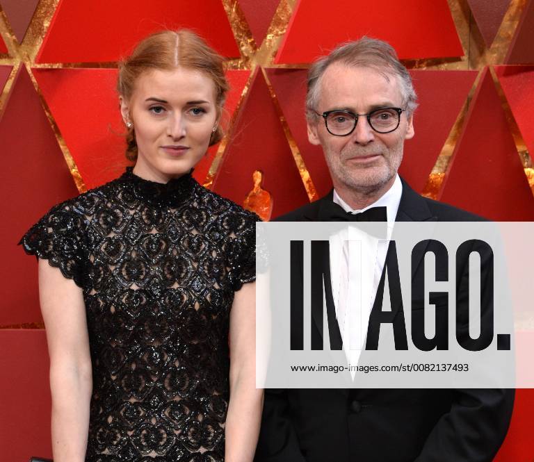 Cinematographer Dan Laustsen (R) and guest arrive on the red carpet for the 90th annual Academy Awards at the Dolby Theatre in the Hollywood section of Los Angeles on March 4, 2018. LAP20180304353 JIMxRUYMEN