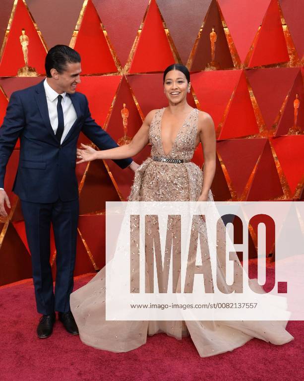 Actors Joe LoCicero (L) and Gina Rodriguez arrive on the red carpet for the 90th annual Academy Awards at the Dolby Theatre in the Hollywood section of Los Angeles on March 4, 2018. LAP20180304365 JIMxRUYMEN