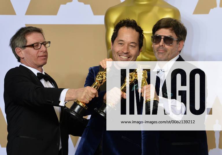 (L-R) Set decorator Jeffrey A. Melvin, production designer Paul Denham Austerberry, and set decorator Shane Vieau, winners of the Best Production Design award for The Shape of Water, appear backstage with his Oscar during the 90th annual Academy Awards at Loews Hollywood Hotel in the Hollywood section of Los Angeles on March 4, 2018. LAP20180304992 JIMxRUYMEN