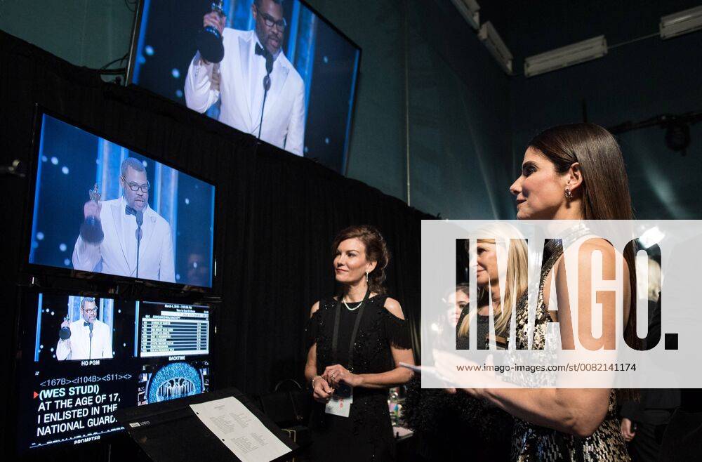 Sandra Bullock watches Jordan Peele accept the Oscar for original screenplay for work on Get Out during the live ABC Telecast of The 90th Oscars® at the Dolby® Theatre in Hollywood, CA on Sunday