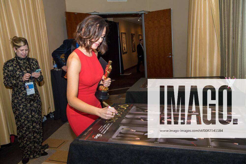 Lucy Sibbick signs a poster backstage with the Oscar for achievement in makeup for work on Darkest Hour during the live ABC Telecast of The 90th Oscars® at the Dolby® Theatre in Hollywood, CA on Sunday