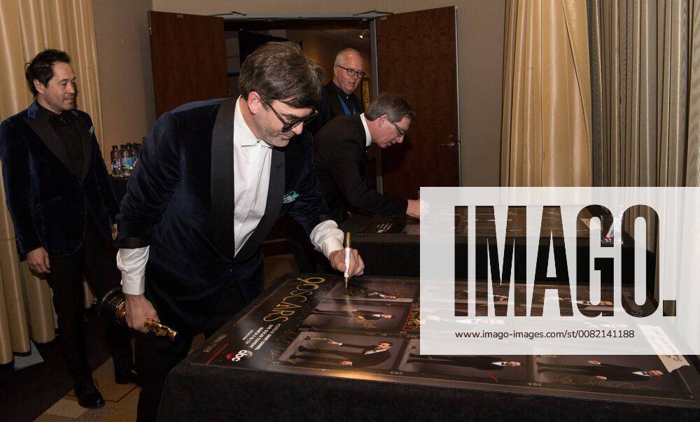 Paul Denham Austerberry (left), Shane Vieau (center), and Jeffrey A. Melvin (right) sign posters backstage after accepting the Oscar for achievement in production design for work on The Shape of Water during the live ABC Telecast of The 90th Oscars® at the Dolby® Theatre in Hollywood, CA on Sunday