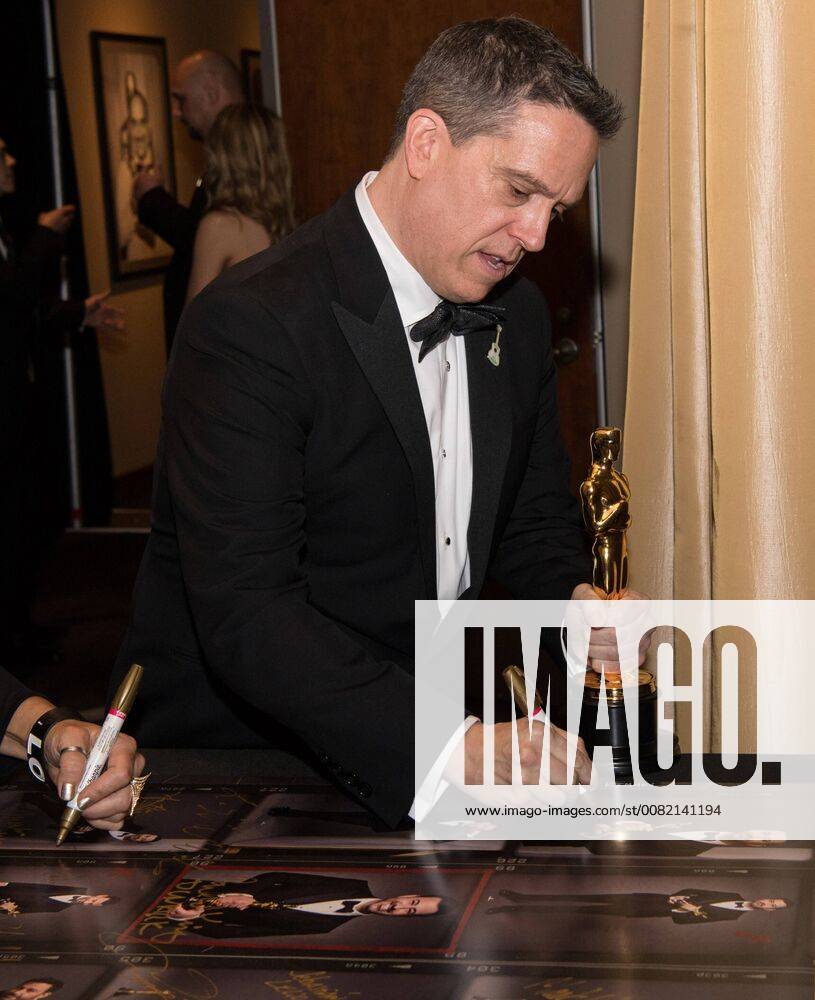 Lee Unkrich signs posters backstage with the Oscar for best animated feature film for work on Coco during the live ABC Telecast of The 90th OscarsÂ® at the DolbyÂ® Theatre in Hollywood, CA on Sunday