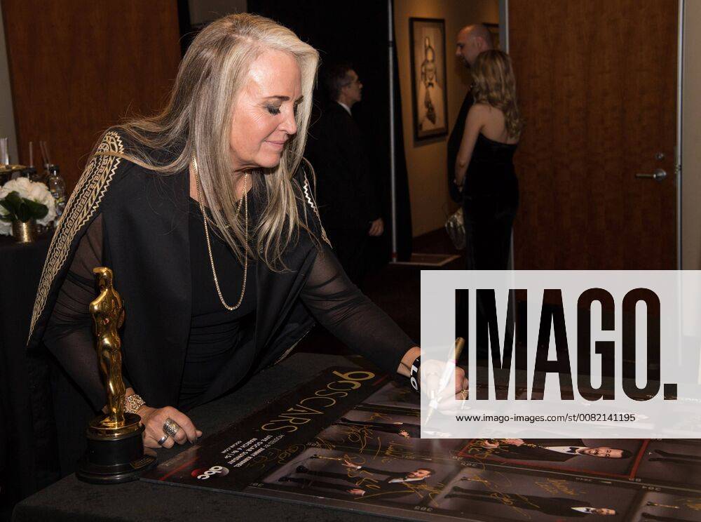 Darla K. Anderson signs posters backstage with the Oscar for best animated feature film for work on Coco during the live ABC Telecast of The 90th Oscars® at the Dolby® Theatre in Hollywood, CA on Sunday