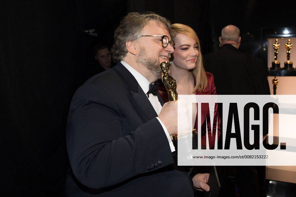 Emma Stone with Guillermo del Toro as he poses backstage with the Oscar for achievement in directing for work on The Shape of Water during the live ABC Telecast of The 90th Oscars® at the Dolby® Theatre in Hollywood, CA on Sunday