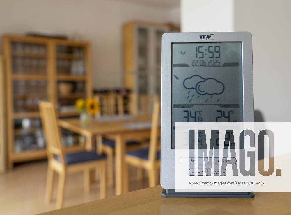 Summer heat, digital thermometer in an attic apartment, city center, outside temperature in the afternoon over 34°C, in the apartment 31°C, apartment without air conditioning, heats up very much, health risk, symbolic image climate change, summer heat apartment