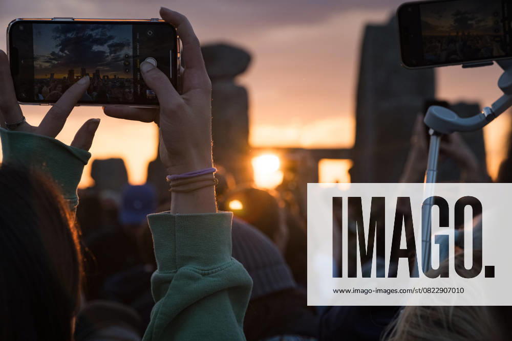 People seen taking photos of the monuments during sunrise. Thousands of people attended the annual festival and watched sunrise celebrating the summer solstice at Stonehenge which signifies the end of spring. Wiltshire United Kingdom - ZUMAs197 20250621_aaa_s197_584