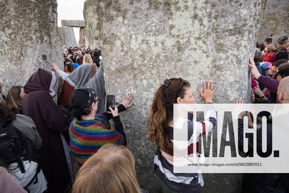 Spectators seen touching the monuments for blessings. Thousands of people attended the annual festival and watched sunrise celebrating the summer solstice at Stonehenge which signifies the end of spring. Wiltshire United Kingdom - ZUMAs197 20250621_aaa_s197_585