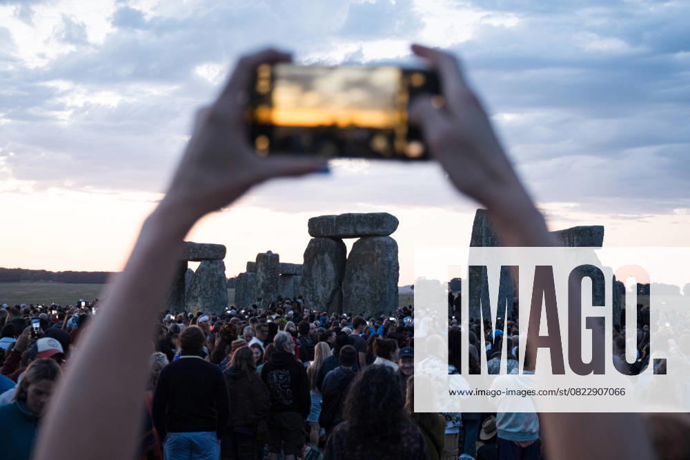 A spectator seen taking photos of the monuments before sunrise. Thousands of people attended the annual festival and watched sunrise celebrating the summer solstice at Stonehenge which signifies the end of spring. Wiltshire United Kingdom - ZUMAs197 20250621_aaa_s197_592