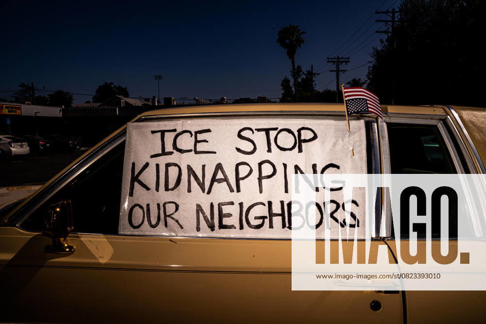 A lowrider decorated with signs sits parked beside the Community Defense Center pop-up tent, symbolizing solidarity and support after 11 confirmed abductions by masked, unidentified men within a one-block radius over three days, in Pasadena, California, on June 27, 2025. Altadena USA - ZUMAp218 20250627_znp_p218_006