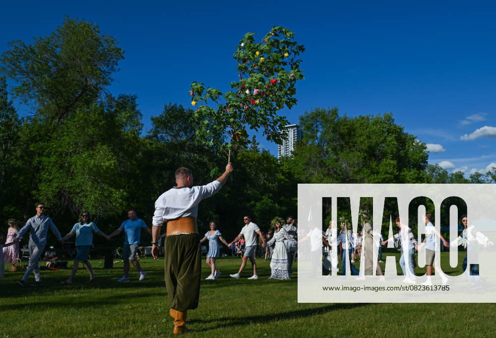 Edmontons Ukrainian Diaspora Honors Kupala Night With Traditional Festivities EDMONTON, CANADA JUNE 29: A man holds a tree decorated with flowers, ribbons, and other adornments symbolizing fertility and the sun, as members of Edmontons Ukrainian community and their friends gather for Kupala Night celebrations organized by the Ukrainian National Youth Federation (UNYF) at Victoria Park in Edmonton, Alberta, Canada, on June 29, 2025. The Ukrainian Kupala Night (or Ivan Kupala) is a centuries-old Slavic folk celebration of the summer solstice, blending pagan and Christian traditions, and also observed in Poland, Belarus, Bulgaria, and Slovakia. It features rituals such as bonfire jumping, water ceremonies, and the symbolic search fo