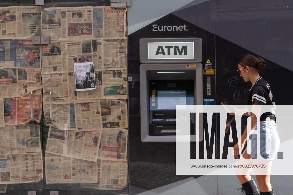 ATM of the provider Euronet placed next to a closed shop in Porto. The company has been criticised for high fees and unfavourable exchange rates, particularly at tourist locations. Portugal GMS19498