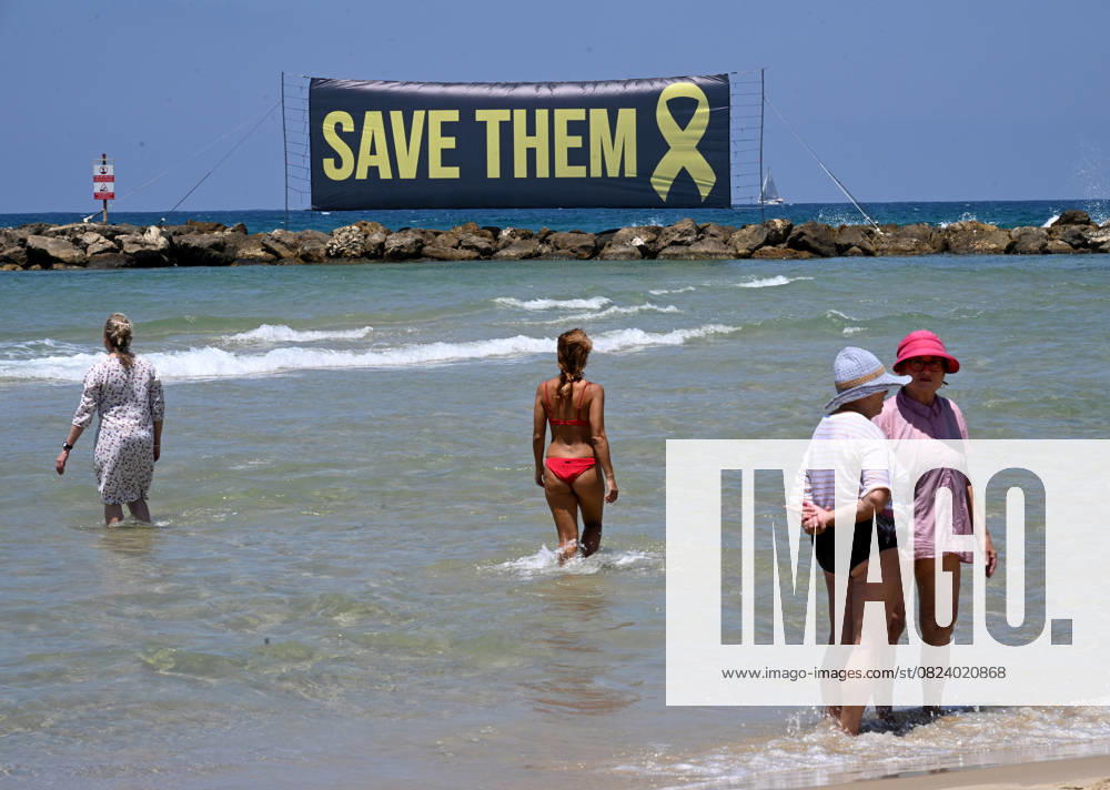 KW27 A banner calling for the release of Israeli hostages still held by Hamas in Gaza since October 7, 2023, is displayed in the Mediterranean Sea in front of the U.S. Embassy branch in Tel Aviv on Friday, July 4, 2025. Released hostages joined families whose loved ones are held in Hamas captivity in a protest calling on U.S. President Donald Trump to bring all the hostages home and end the war. JER2025070402 DEBBIExHILL