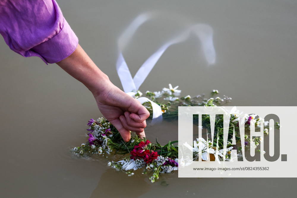 RUSSIA, RYAZAN REGION - JULY 5, 2025: A woman places a wreath in the water during a celebration marking Ivan Kupala Day at Akvamarin Holiday Centre. Alexander Ryumin TASS 82261466