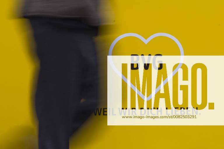 A person is passing a logo of the BVG Berliner Verkehrsgesellschaft in Berlin 26 03 2018 Berlin Germany